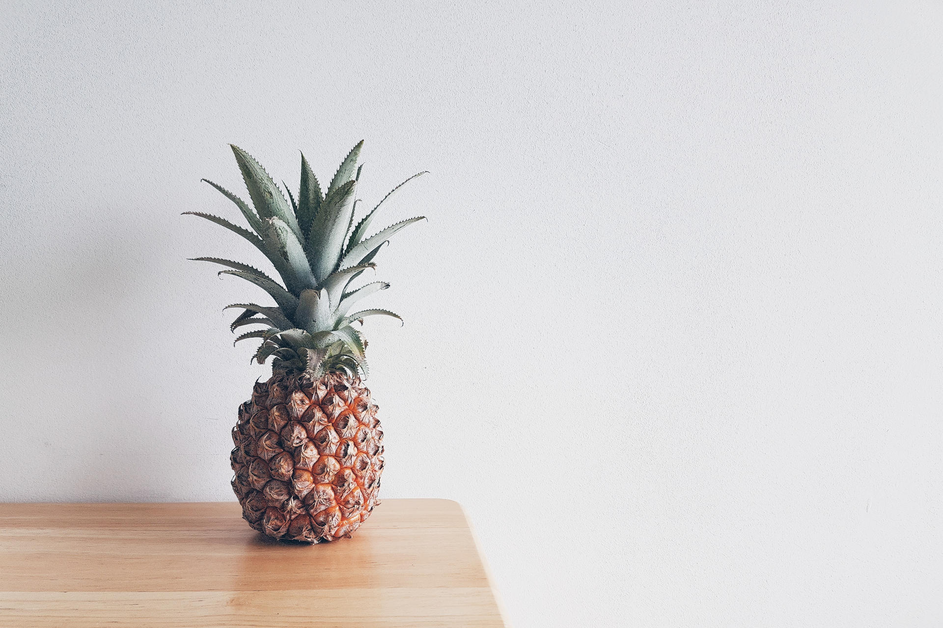 Pineapple on a beige wooden table